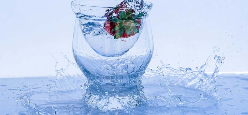 Glass of water with a strawberry